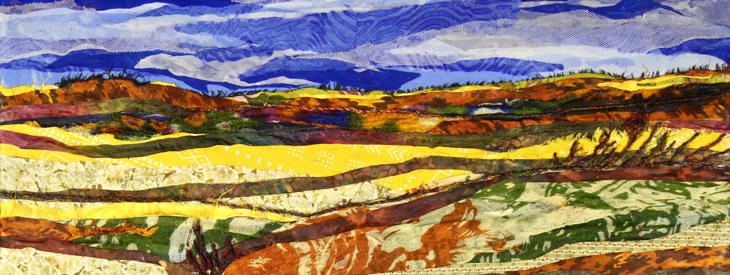 Fabric art by artist Pam Collins titled "Fall on the Prairie"
